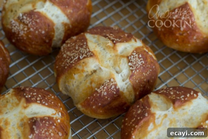 Pretzel Rolls 5 A close up of bretzel rolls resting on a wire cooling rack, showing the detail of the salty crust.