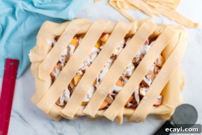 Heavenly Deep Dish Peach Pie 14 strips of pie dough neatly spread crosswise over the peach filling in the pan