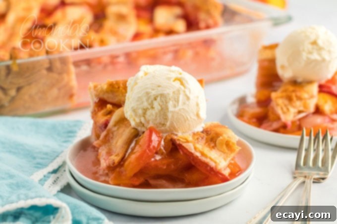 Heavenly Deep Dish Peach Pie 17 slice of warm peach pie on a white plate, generously topped with melting vanilla ice cream and a garnish of fresh mint