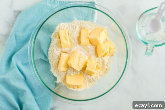 Heavenly Deep Dish Peach Pie 6 flour mixture in bowl with chunks of shortening on top, ready for blending