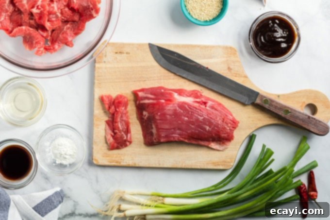 Khan's Caramel Beef 4 flank steak on a cutting board, prepared for slicing for the Mongolian Beef