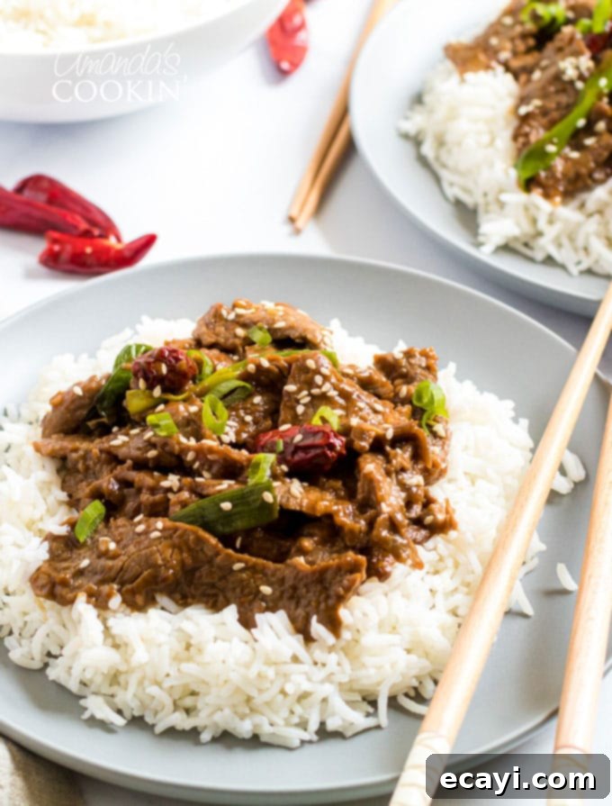 Khan's Caramel Beef 10 plate of Mongolian Beef with chop sticks over rice, ready to be enjoyed
