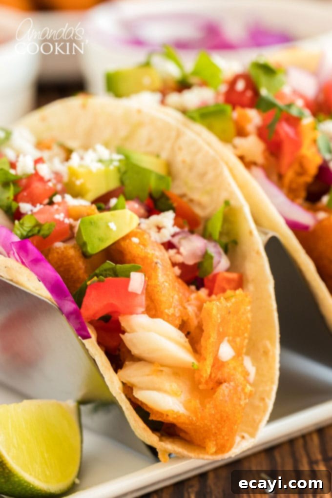 Your New Favorite Fish Tacos 4 a perfectly assembled fish taco in a metal taco holder