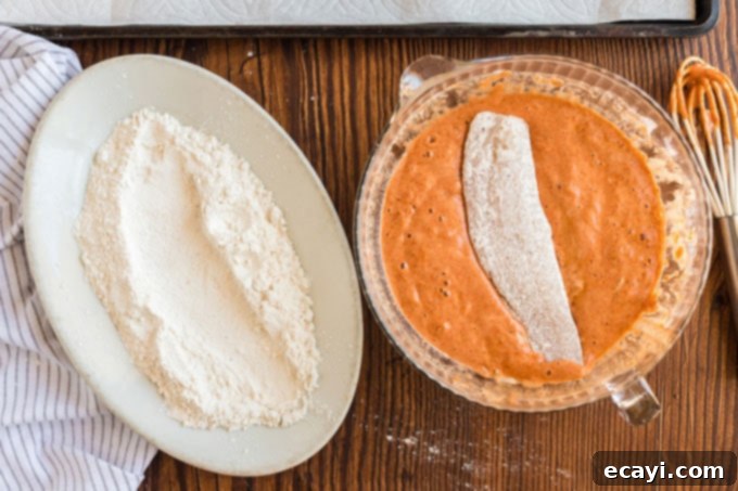 Your New Favorite Fish Tacos 8 beer battering fish for tacos, showing the coating process