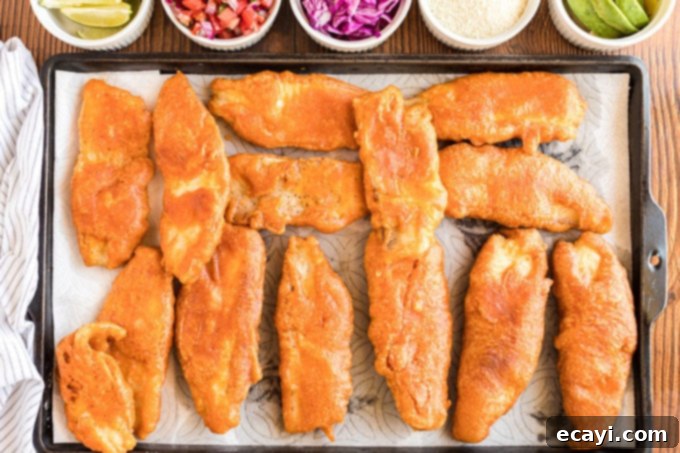 Your New Favorite Fish Tacos 10 fried fish draining on paper towels, ready to be assembled into tacos