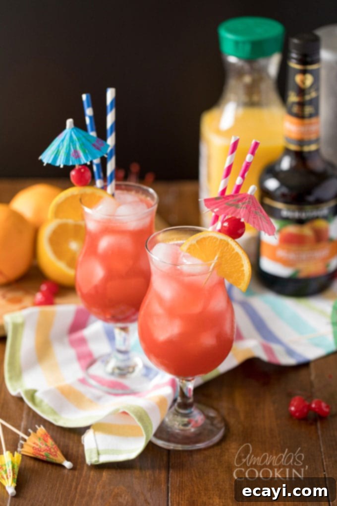 Seaside Seduction 3 sex on the beach cocktail in hurricane glass with straws
