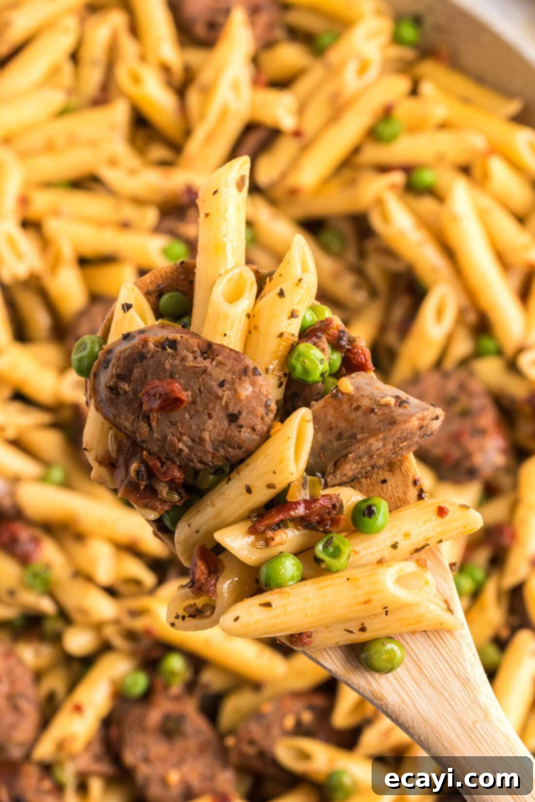 Hearty Sausage Penne With Peas 15 Close up photo of a spoonful of Sausage, Penne & Peas, showing the texture and ingredients.