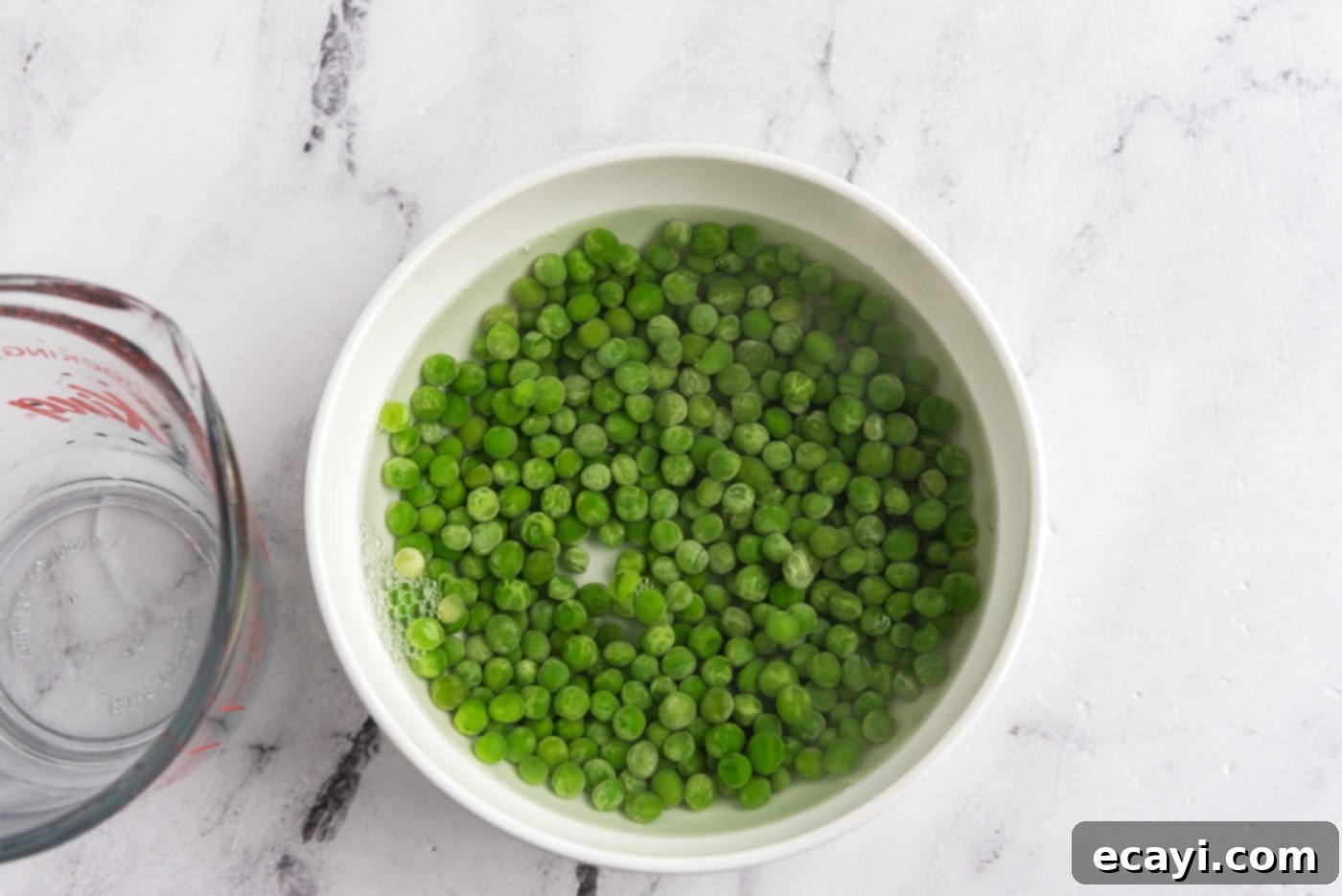 Hearty Sausage Penne With Peas 7 peas in a bowl with hot water