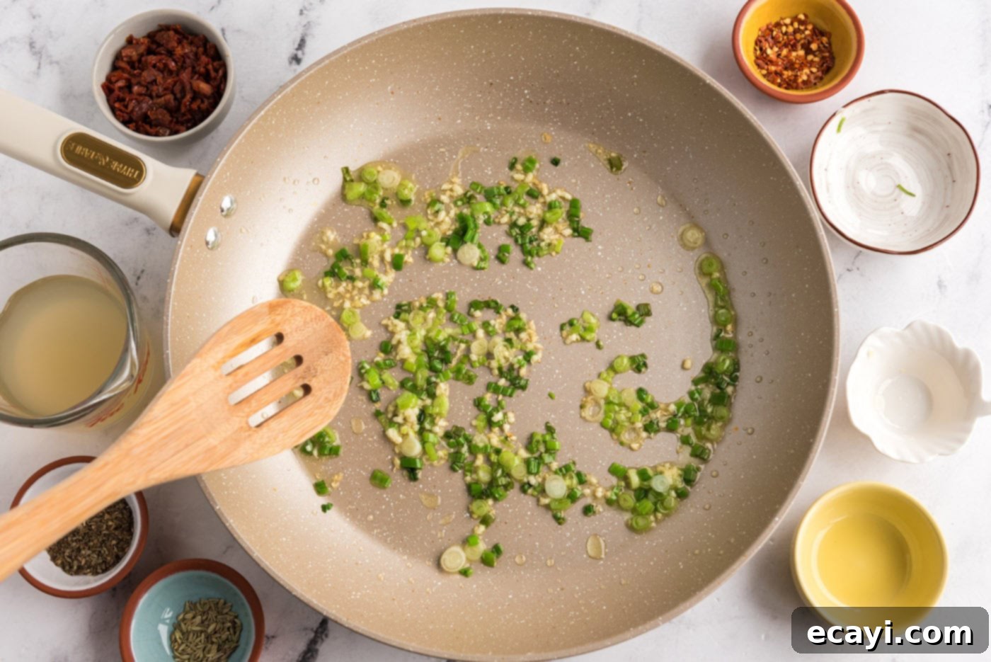 Hearty Sausage Penne With Peas 8 sauteeing garlic and scallions in a skillet