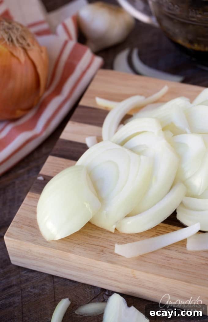 Traditional Amish Pot Roast 4 Slicing fresh onions thinly for the Amish Pot Roast recipe, preparing them for the Dutch oven.