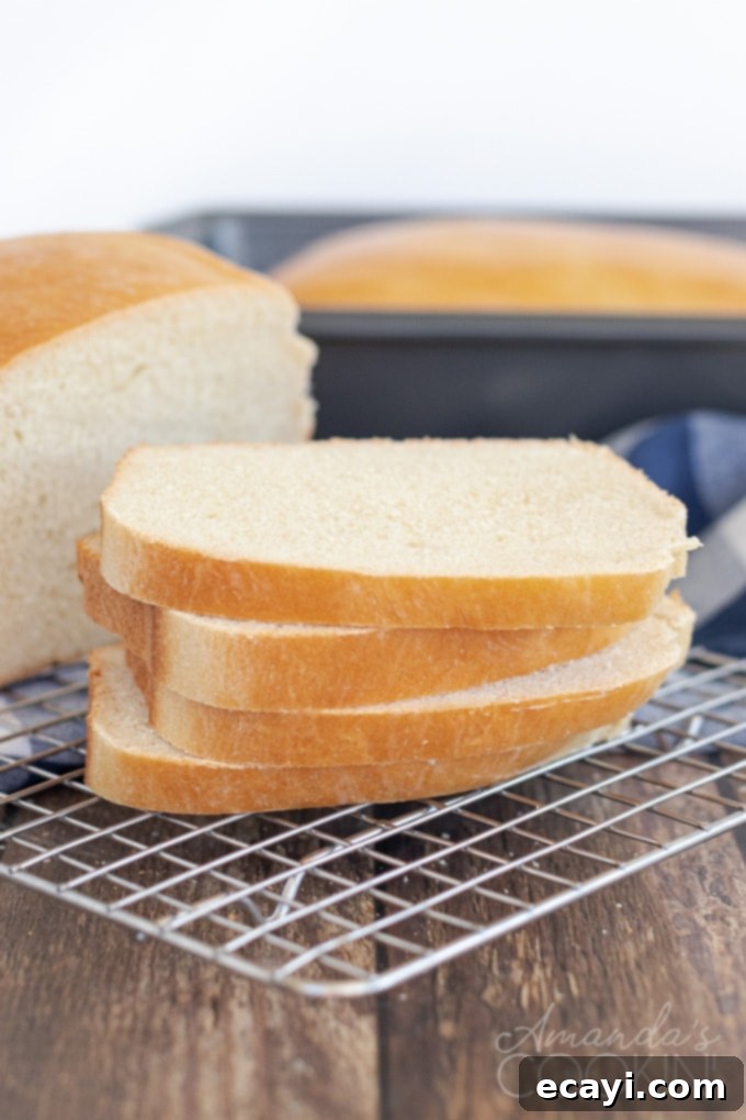 Homemade Amish white bread is ideal for sandwiches, French toast, grilled cheese, or your breakfast toast. Warm homemade bread is great with dinner too! Sliced Amish white bread on a wire rack, ready for serving or cooling