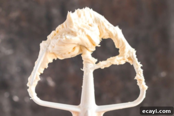 Timeless White Cake 6 stand mixer paddle attachment covered in cream cheese mixture