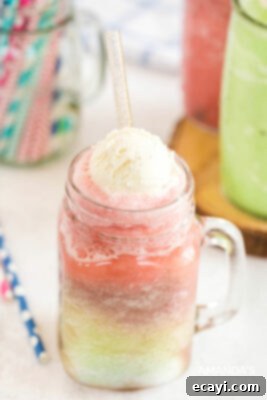 Kitchen Crafted Slush Floats 10 Layered red slushie float with vanilla ice cream in a mason jar.