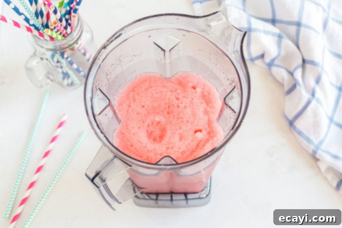 Kitchen Crafted Slush Floats 7 The blender filled with a perfectly blended red slushie, showcasing its smooth, icy consistency.