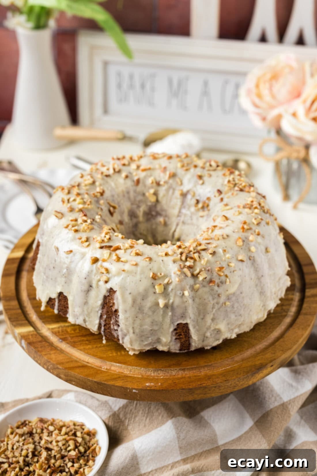 Velvet Banana Bundt 2 Banana Bundt Cake on a wooden cake stand with a slice removed