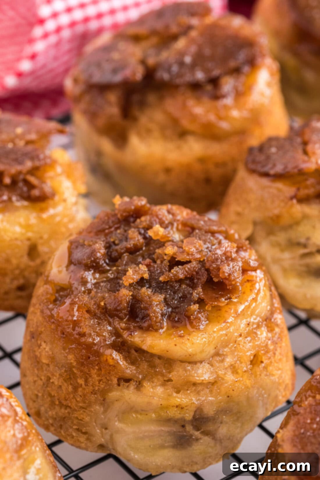 Sticky-Sweet Banana Crown Muffins 2 Close up photo of a Banana Upside Down Muffin showing the caramelized banana topping and fluffy interior