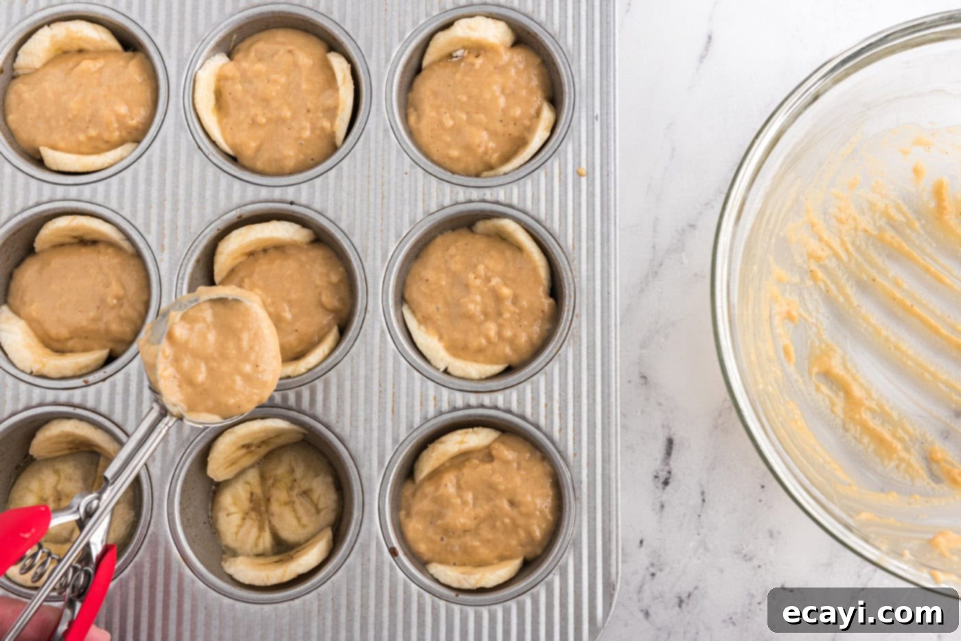 Sticky-Sweet Banana Crown Muffins 13 adding muffin ingredients to banana lined muffin pan