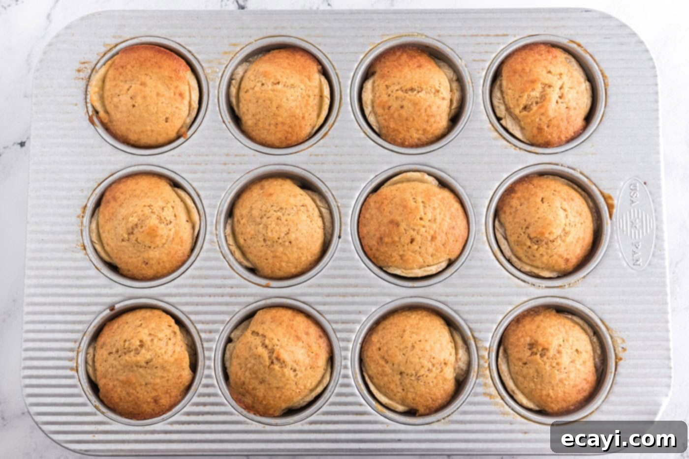 Sticky-Sweet Banana Crown Muffins 14 baked banana upside down muffins ready to be removed from oven