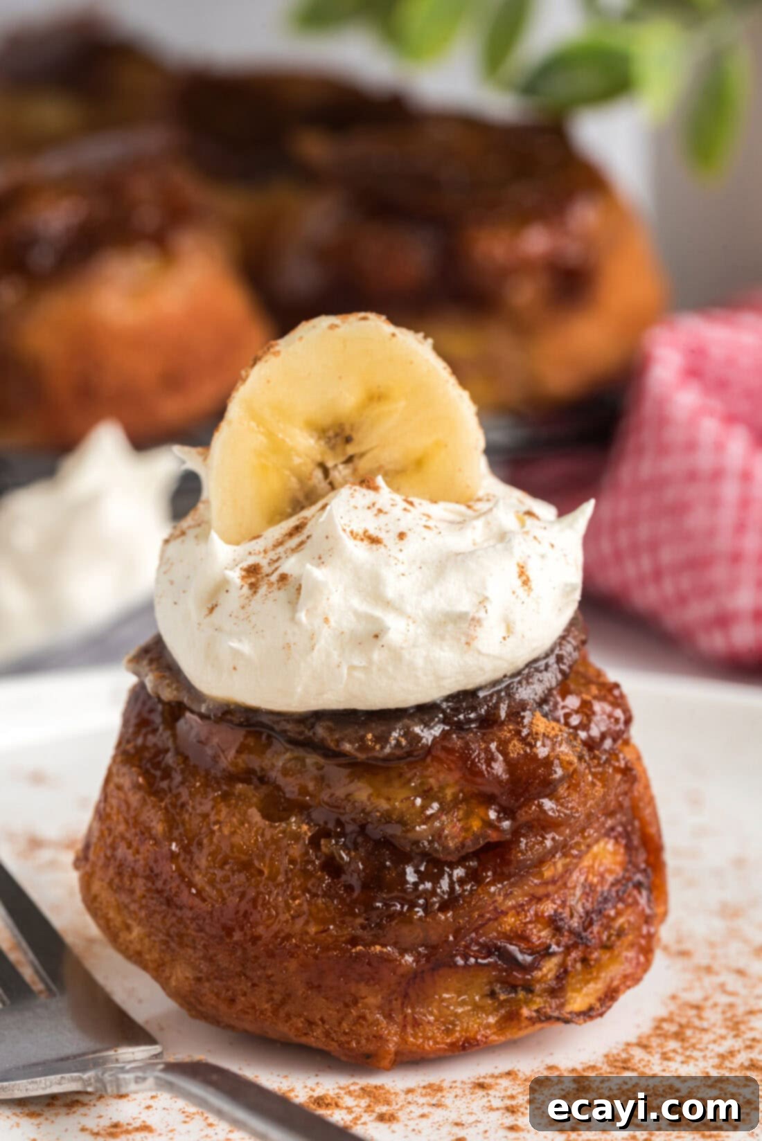 Sticky-Sweet Banana Crown Muffins 3 Banana Upside Down Muffin topped with whipped cream and a banana slice