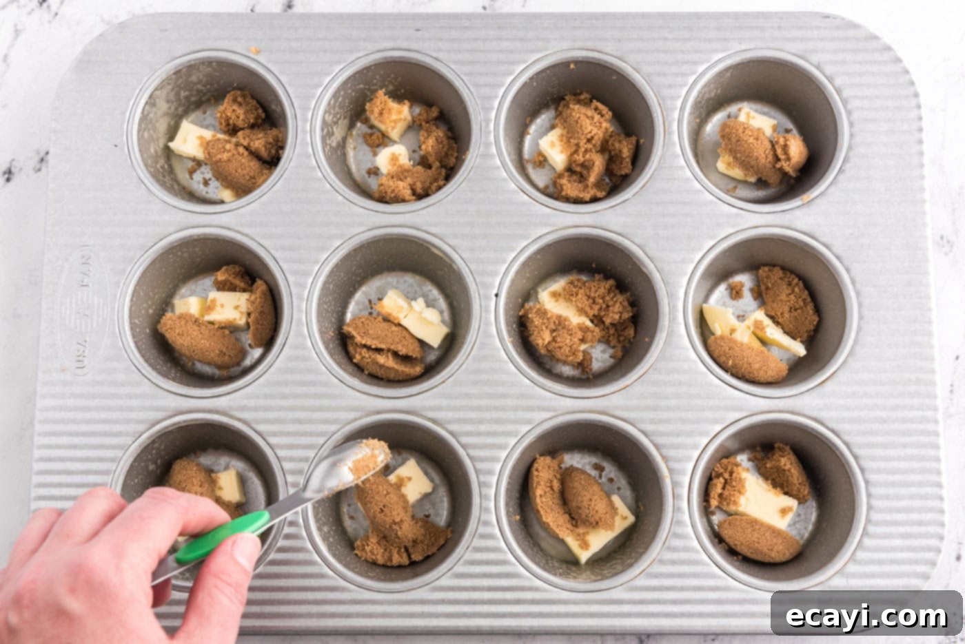 Sticky-Sweet Banana Crown Muffins 5 butter and dark brown sugar in wells of a muffin pan