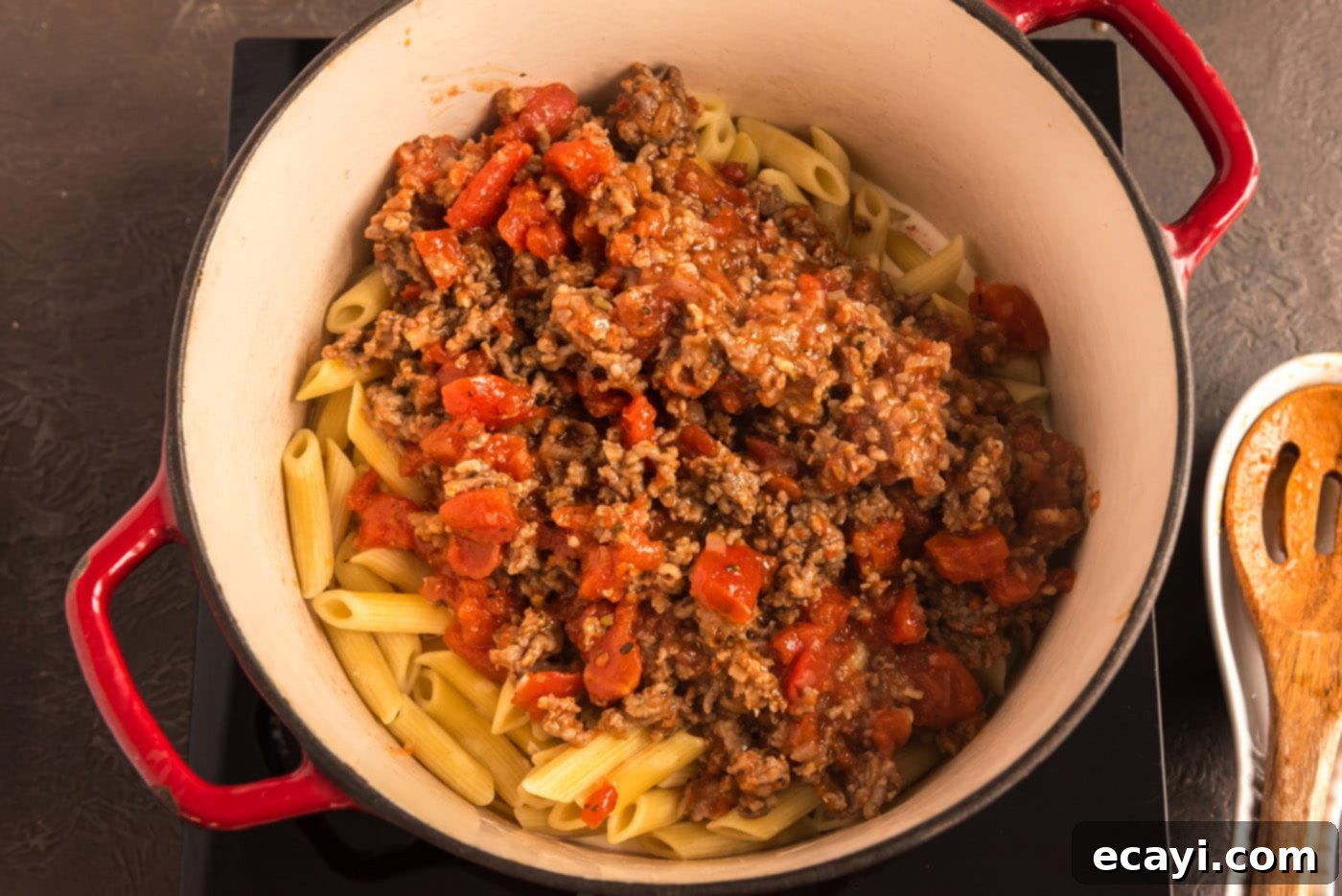 Tomato Sage Sausage Penne 11 adding tomato and sausage sauce to pan with pasta