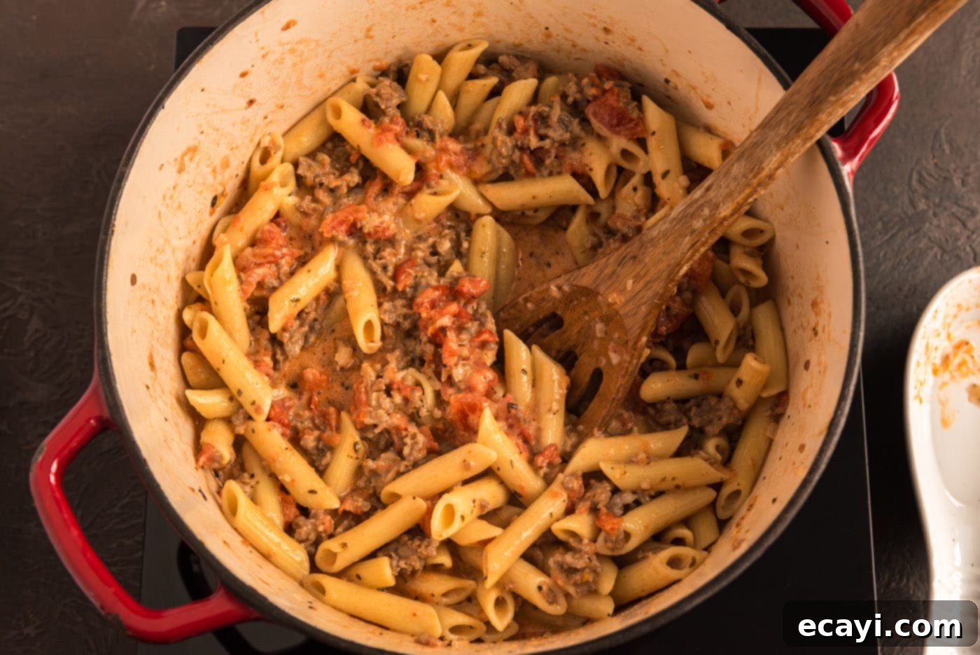 Tomato Sage Sausage Penne 12 penne with tomato sage sausage sauce in a pot, ready to serve