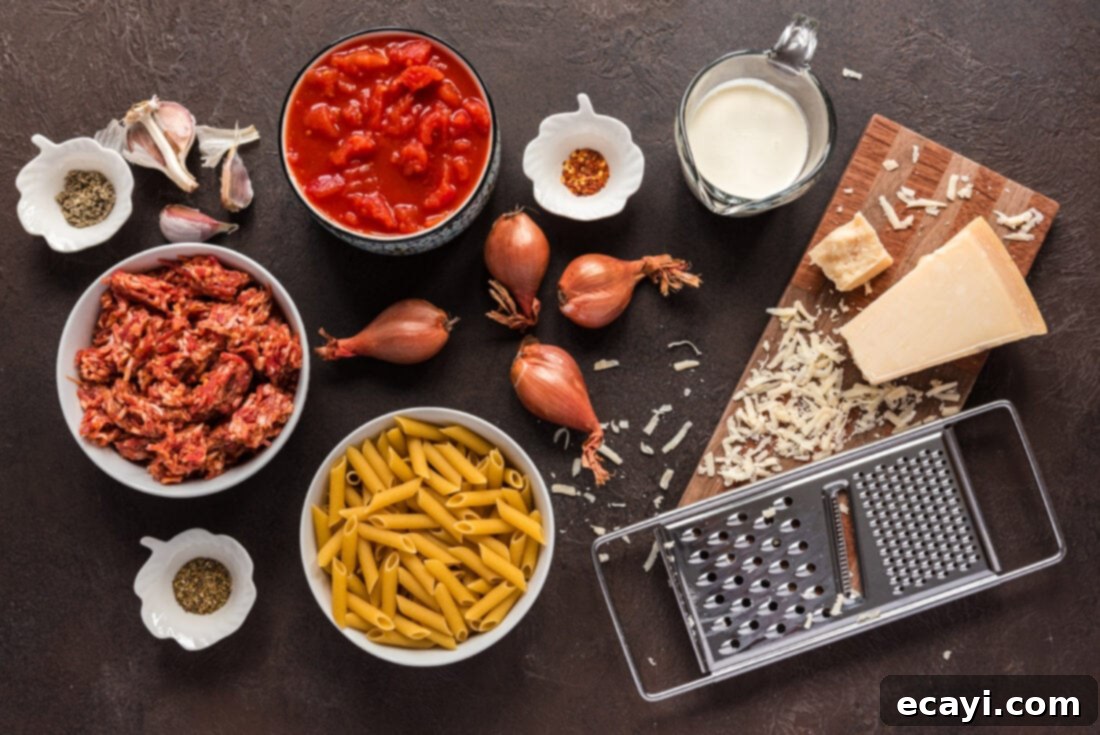Tomato Sage Sausage Penne 4 Ingredients for Penne with Tomato Sage Sausage Sauce laid out on a cutting board