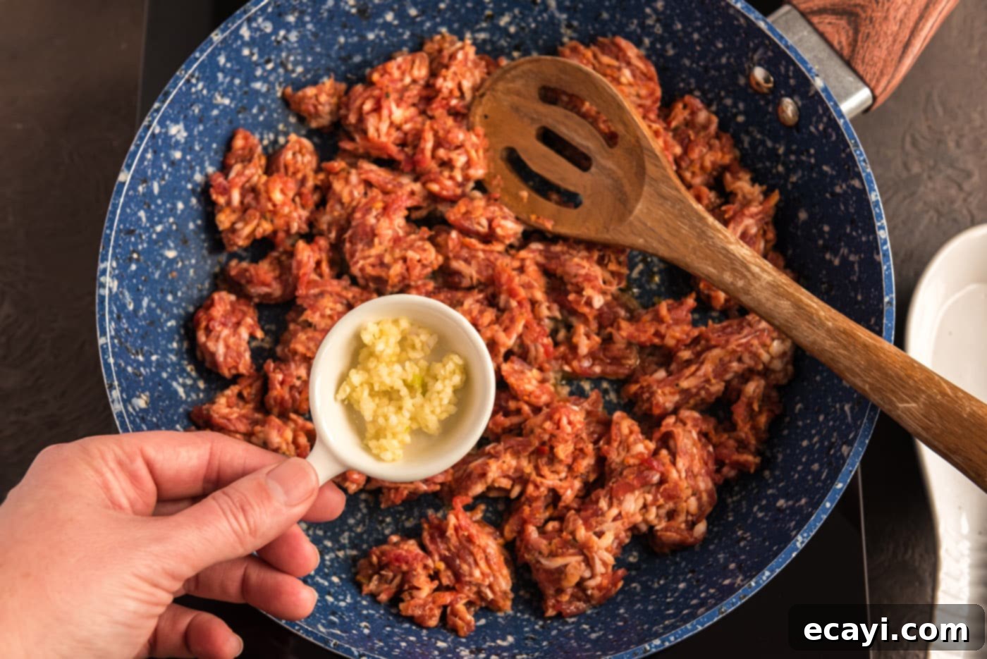 Tomato Sage Sausage Penne 5 adding garlic to pan with ground pork sausage