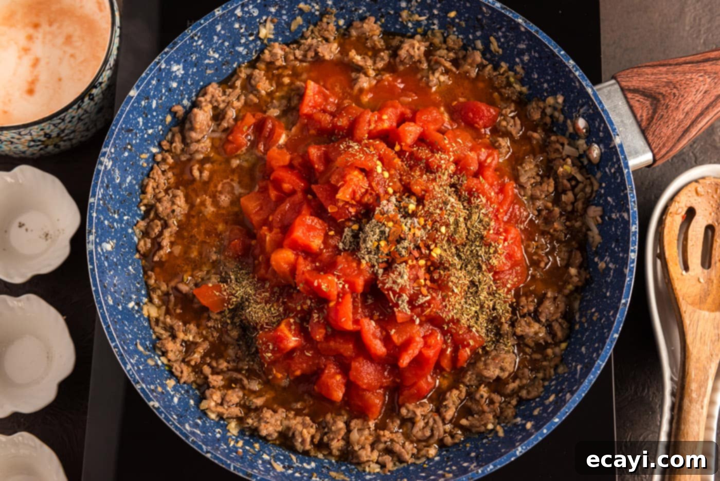 Tomato Sage Sausage Penne 8 diced tomatoes and seasonings added to ground sausage in skillet