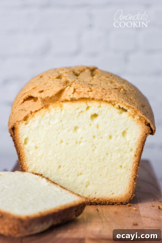 Elvis Presley's favorite pound cake recipe, made with a perfect balance of butter, eggs, flour, sugar, and the secret ingredient: whipping cream. A beautifully baked whipping cream pound cake with a generous slice removed, showcasing its dense and moist interior.