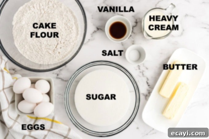 Velvety Whipping Cream Pound Cake 2 Neatly labeled ingredients including butter, sugar, eggs, flour, vanilla, salt, and heavy cream laid out for baking the pound cake recipe.