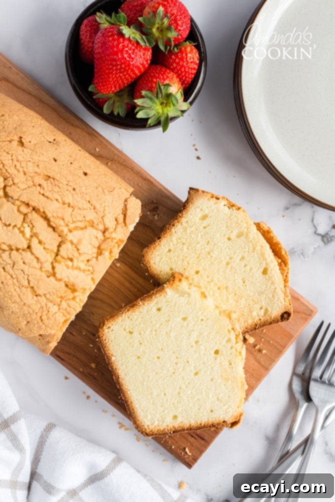 Enjoy this moist and delicious pound cake with your favorite toppings or simply on its own. Overhead view of a perfectly sliced pound cake on a wooden cutting board, ready to be served.