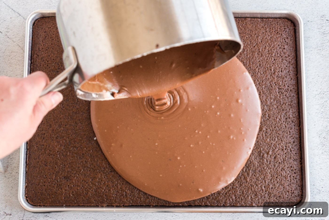 Texas-Sized Chocolate Dream 13 pouring chocolate icing over hot chocolate sheet cake