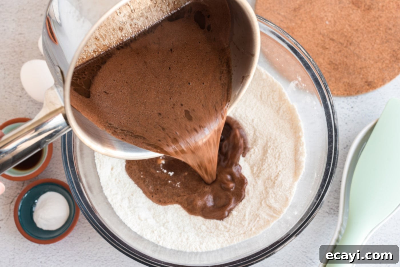 Texas-Sized Chocolate Dream 7 pouring chocolate batter over dry ingredients
