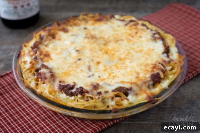 Pasta Pie Perfection 9 A full, golden-brown spaghetti pie, fresh from the oven, promising an easy, hearty, and delicious weeknight dinner that is perfect for family gatherings or meal prep.