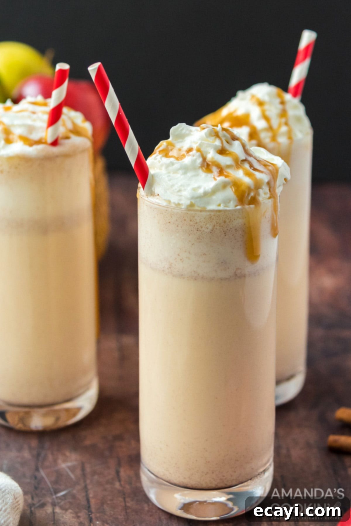 Only 3 ingredients for this delicious, fall inspired apple cider milkshake. So easy to make and an amazing way to wrap up summer. Three tall glasses of apple cider milkshakes garnished with whipped cream and cinnamon