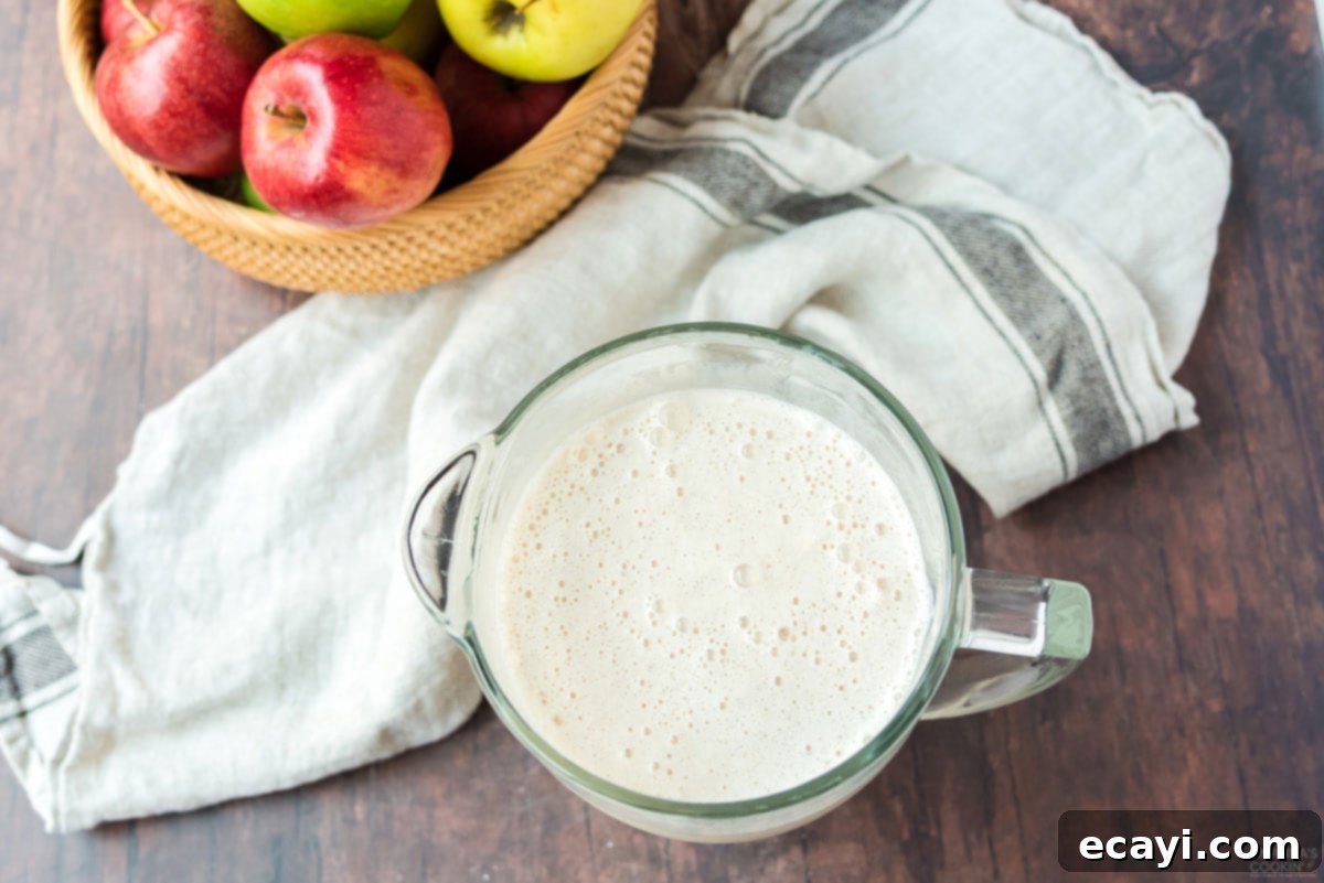 Crisp Apple Cream Shake 4 A measuring cup filled with freshly blended apple cider milkshake