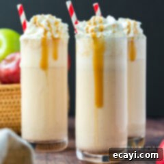 Crisp Apple Cream Shake 5 Two tall glasses of apple cider milkshakes garnished with whipped cream and cinnamon