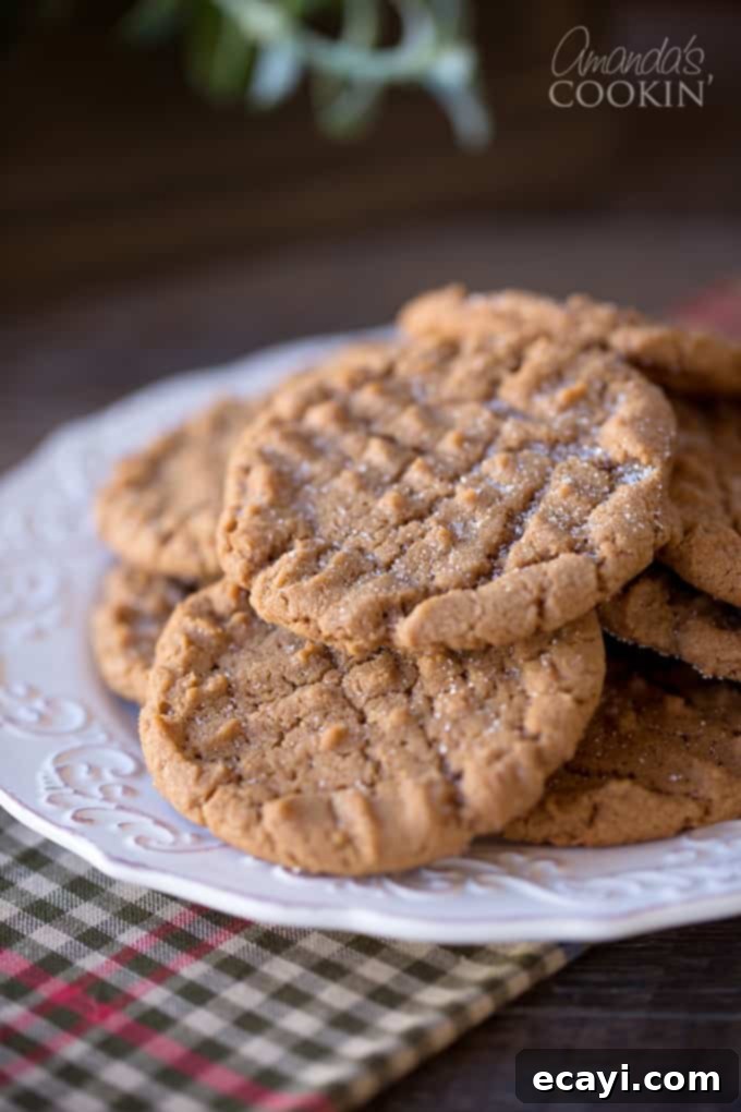 Decadent Nutella Peanut Butter Cookies 2 A close up photo of freshly baked Nutella peanut butter cookies resting on a plate, showcasing their soft texture and signature fork marks.