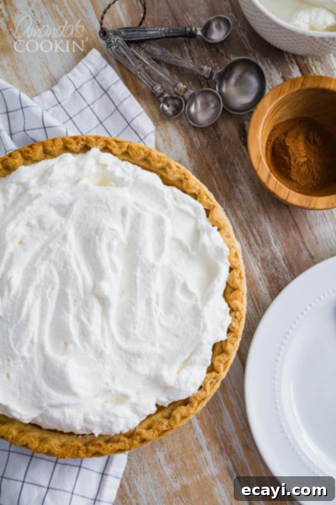 The Perfect Pumpkin Pie A beautiful whole pumpkin pie, ready for slicing, showing its golden-brown top and crimped crust