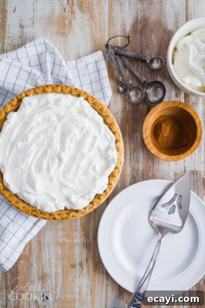 Don't miss out on this delicious pumpkin pie recipe this holiday season! An overhead shot of a whole pumpkin pie, showcasing its golden crust and smooth surface, ready to be sliced and enjoyed.