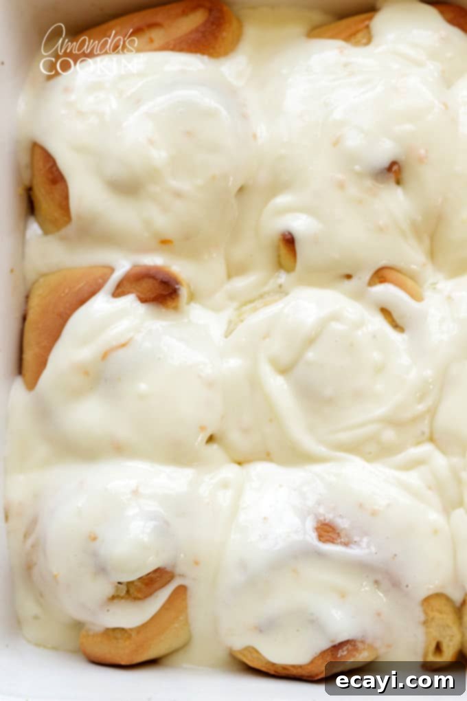 You'll love these orange rolls just as much as homemade cinnamon rolls. This quick orange rolls recipe is ideal for those who prefer homemade over canned. #orangerolls #cinnamonrolls #breakfastrolls #orange #creamcheese #creamcheesefrosting #sweetrolls #orangerollsrecipe #breakfast #sweetrollrecipe orange rolls covered in frosting