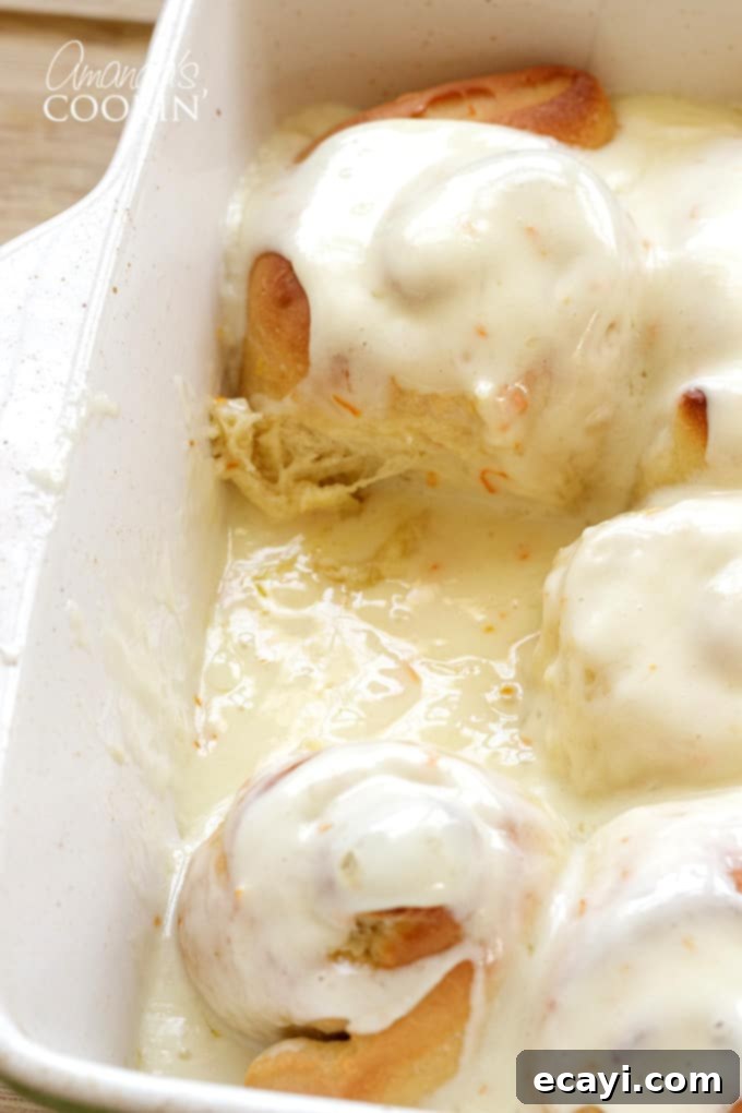 You'll love these orange rolls just as much as homemade cinnamon rolls. This quick orange rolls recipe is ideal for those who prefer homemade over canned. #orangerolls #cinnamonrolls #breakfastrolls #orange #creamcheese #creamcheesefrosting #sweetrolls #orangerollsrecipe #breakfast #sweetrollrecipe piece missing from orange rolls pan