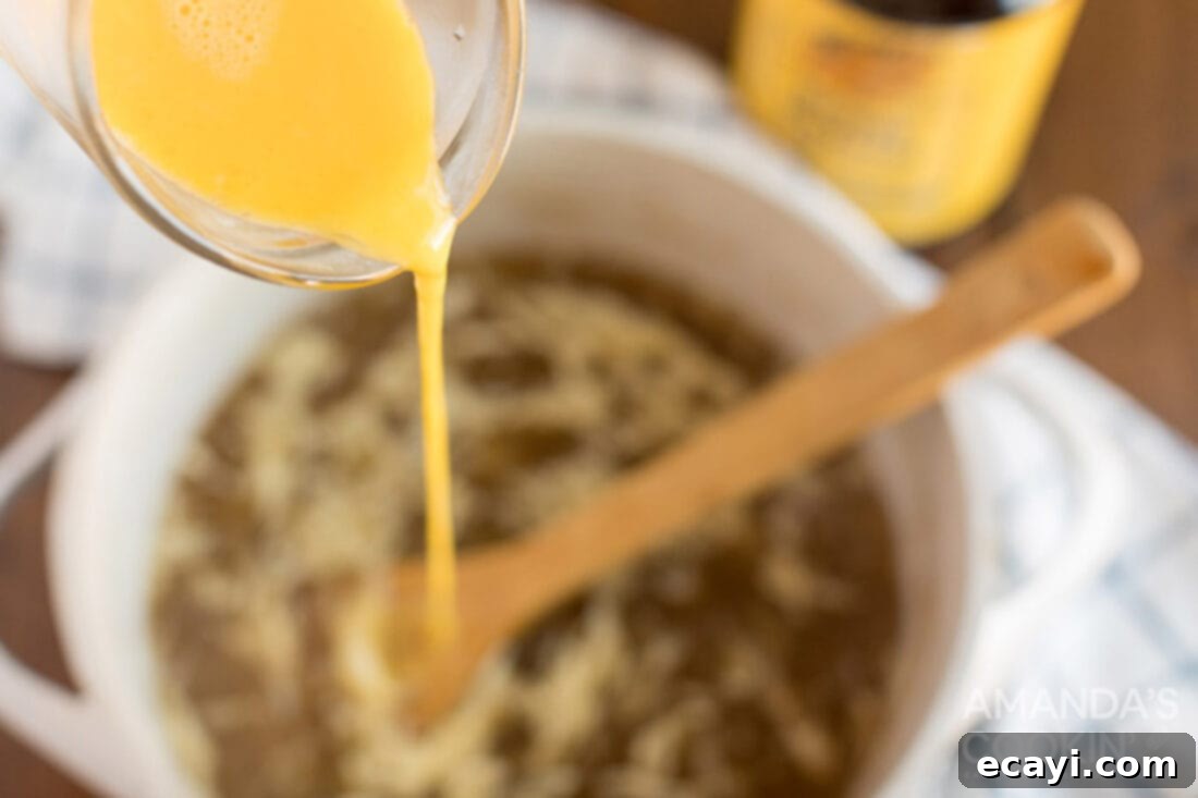 Golden Egg Flower Soup 4 slowly drizzling beaten egg into simmering broth while stirring to create delicate egg ribbons