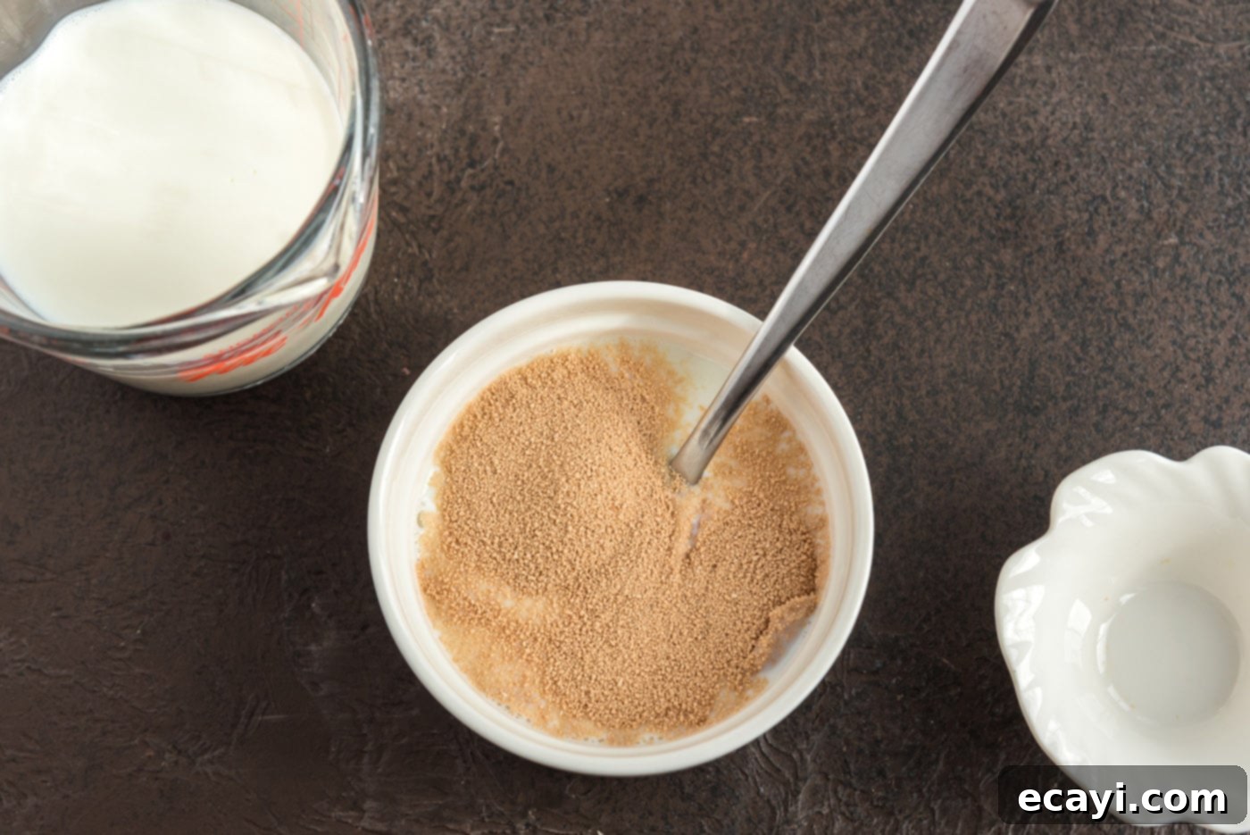 Hearty German Party Loaf 5 mixing active dry yeast with milk in a bowl