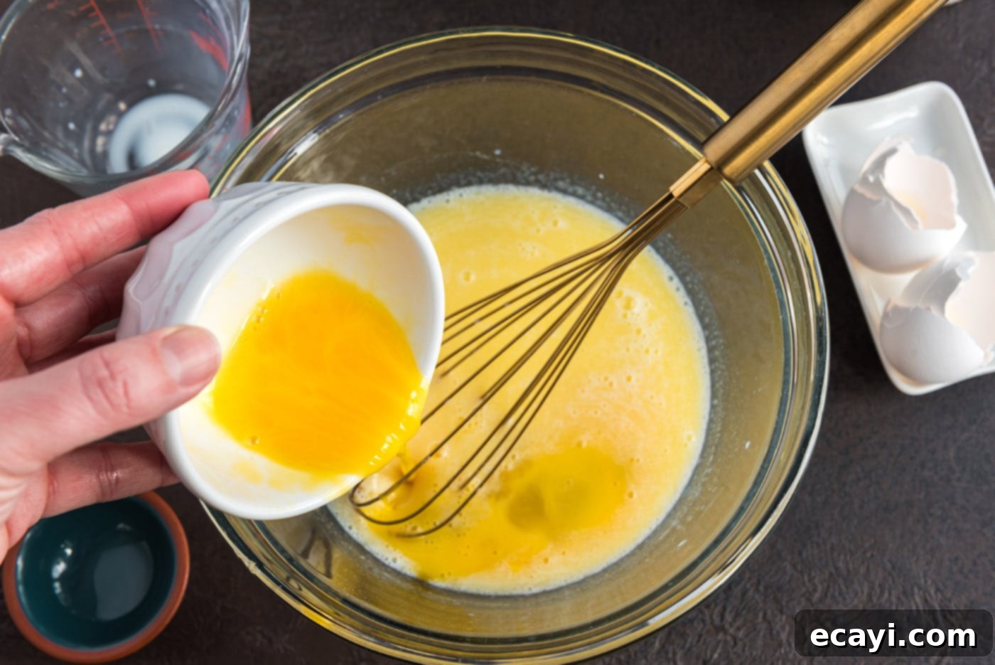 Hearty German Party Loaf 7 adding beaten egg to bowl of butter, milk, and sugar mixture
