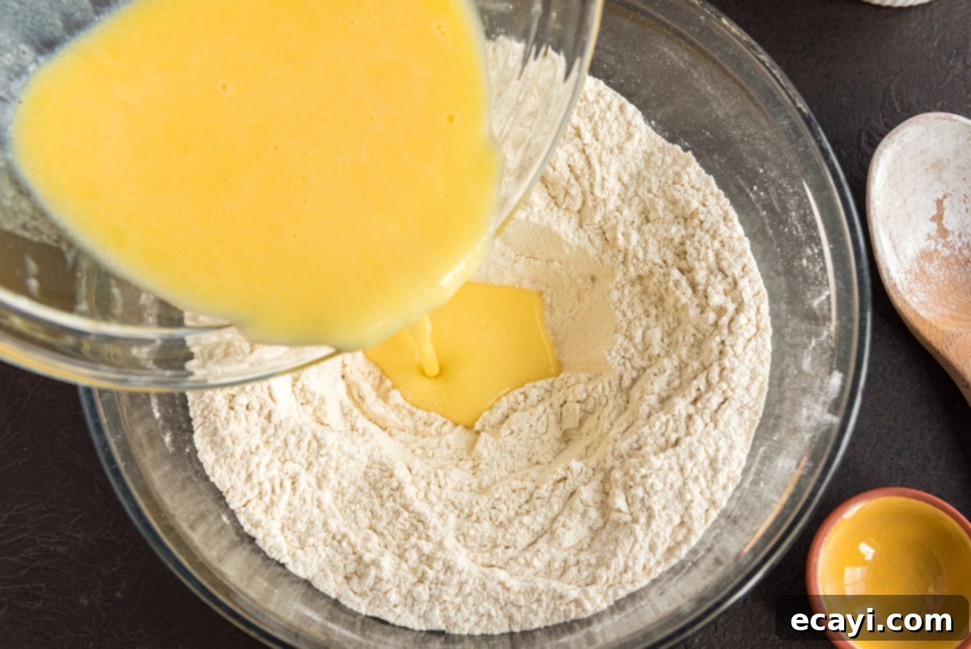 Hearty German Party Loaf 10 pouring melted butter and egg mixture into well of flour