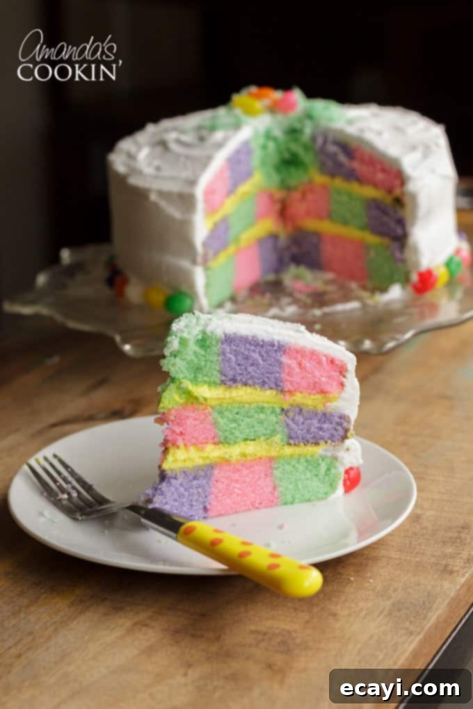 This Checkerboard Cake is the perfect treat for Easter- impress your friends and family with a colorful cake for the holiday! #easter #easterdessert #easterrecipes #cake #checkerboardcake #cakerecipes #cutefood #frosting Checkerboard cake