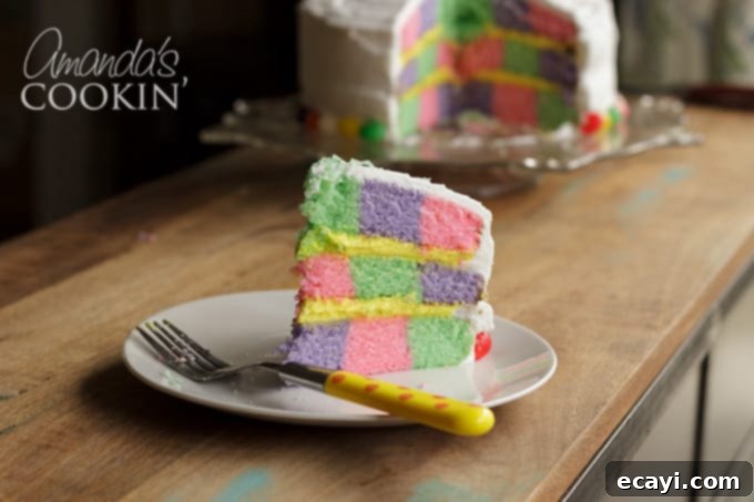 This Checkerboard Cake is the perfect treat for Easter- impress your friends and family with a colorful cake for the holiday! #easter #easterdessert #easterrecipes #cake #checkerboardcake #cakerecipes #cutefood #frosting pastel colored checkerboard cake for easter