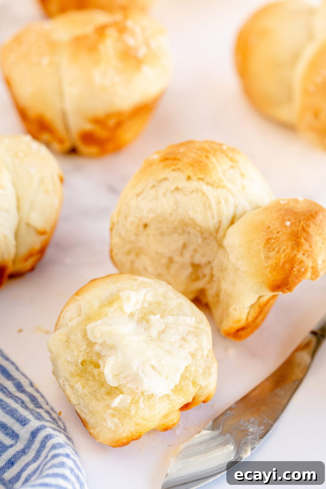 Irresistible Tear-and-Share Dinner Buns 12 A freshly baked Homemade Pull Apart Dinner Roll with a pat of melting butter on top, enticingly warm.